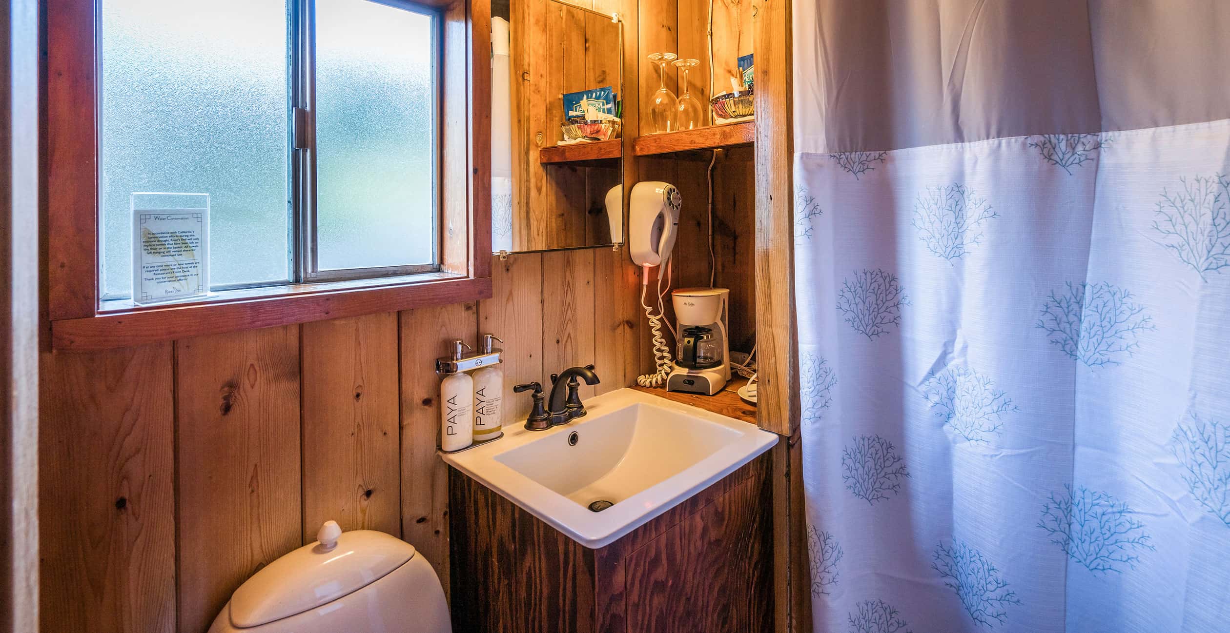 Sink by shower curtain in pristine Cabin 3 bathroom