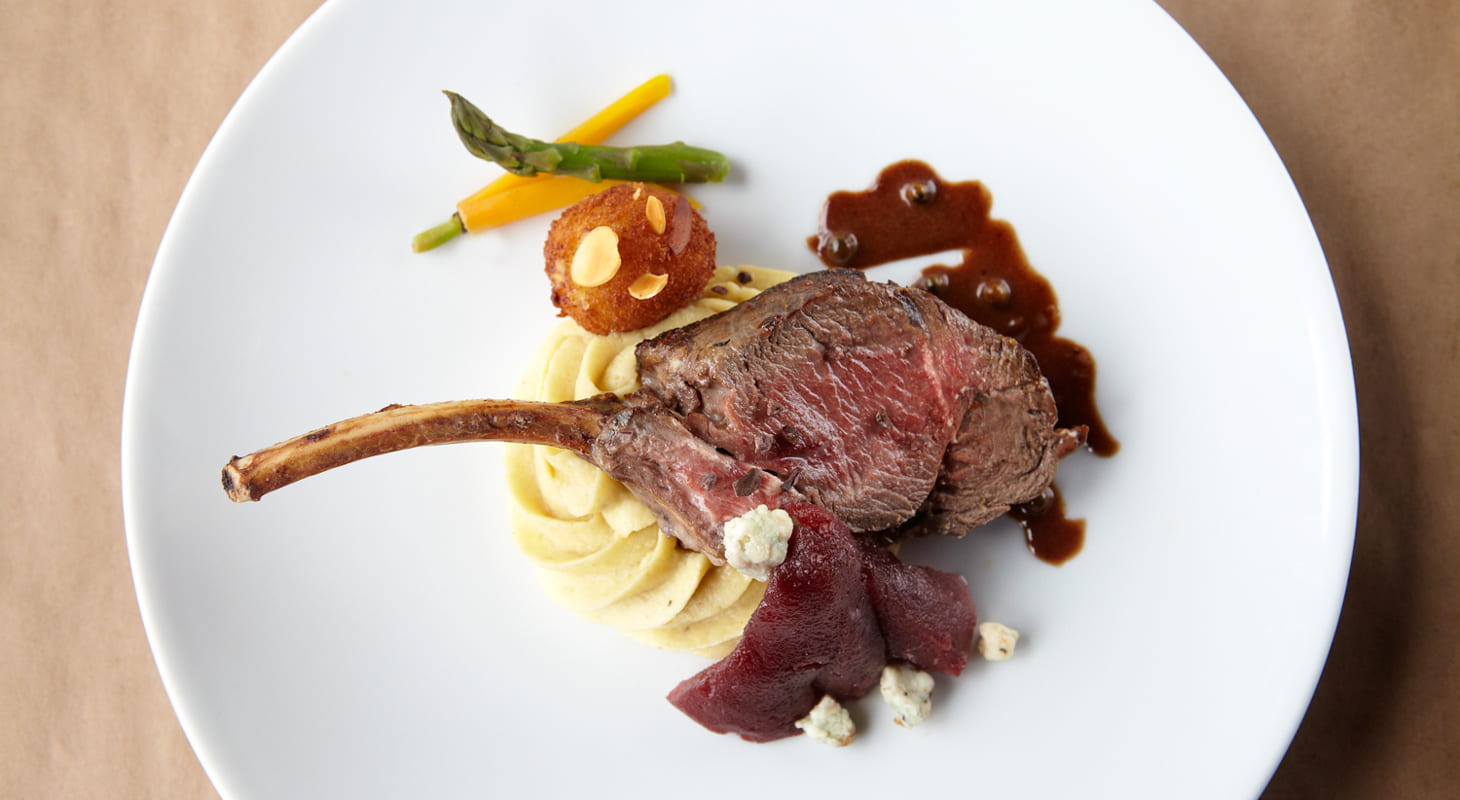 Lamb served with potatoes and roasted veggies